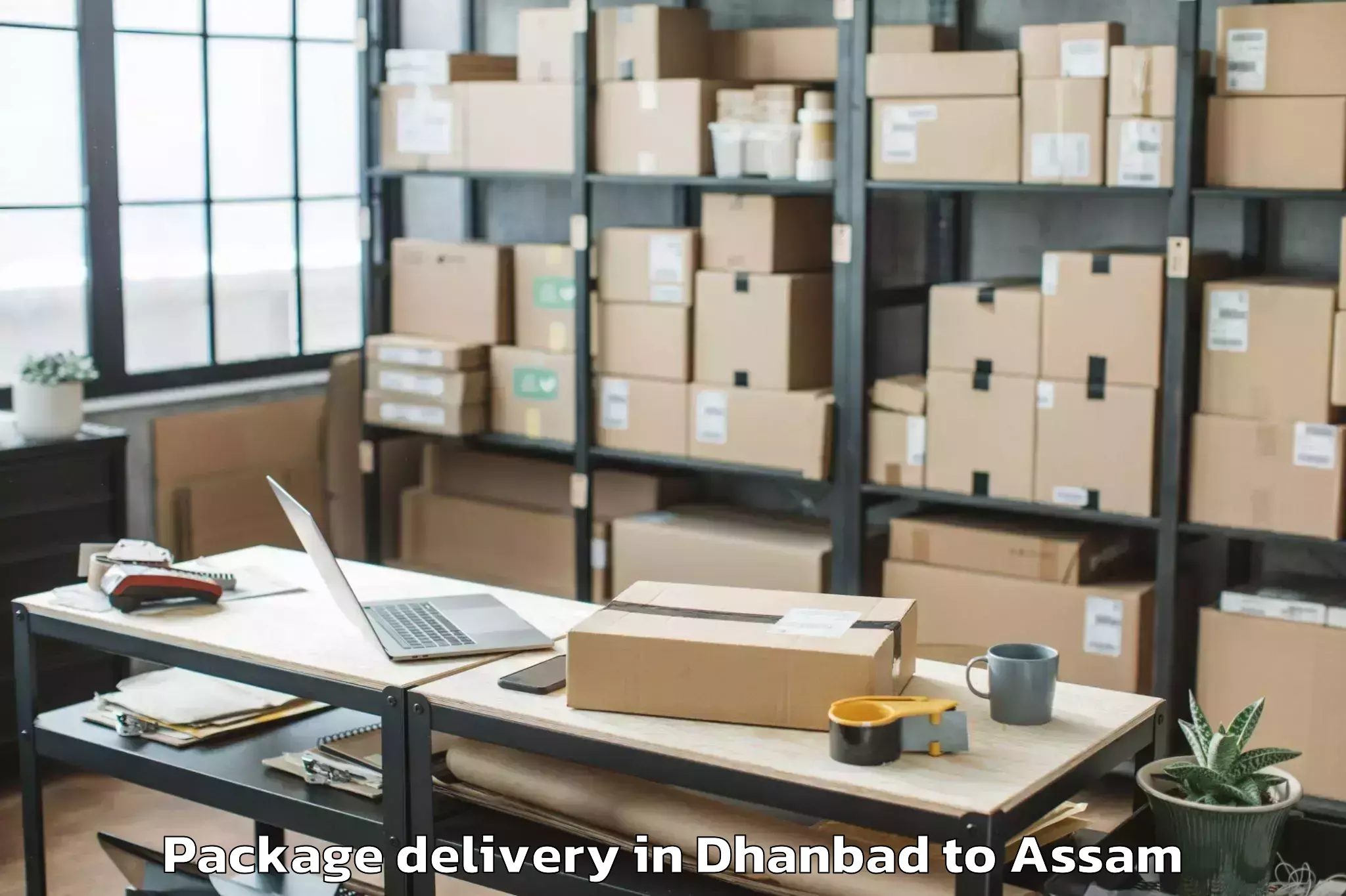 Book Dhanbad to Chariduar Package Delivery Online